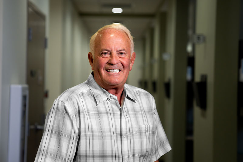 headshot of patient smiling brightly after their dental procedure