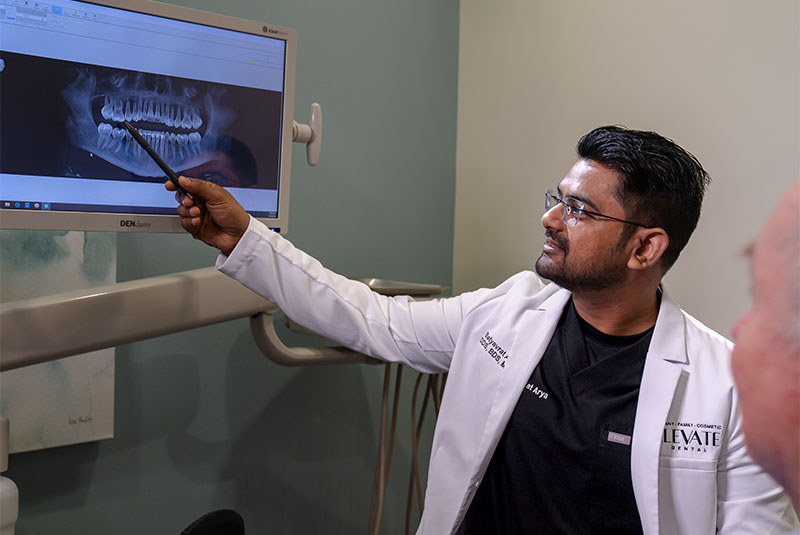 Doctor looking at dental x-ray with Patient