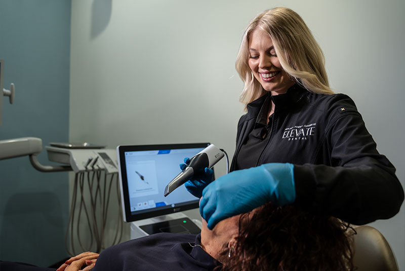 staff member performing dental procedure for patient